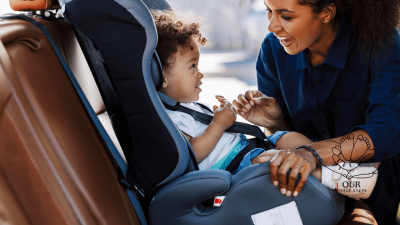 A variety of car seats for babies and young children displayed in a bright, family-friendly environment, showcasing different styles and safety features.