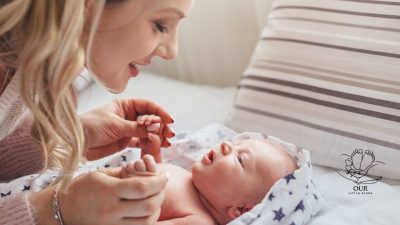 A parent smiling and talking to a baby who is happily babbling back.