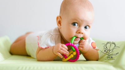 A mother gently cleaning her baby's teeth with a soft brush, promoting healthy oral care for newborns