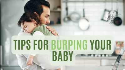 A parent gently burping a baby over their shoulder, promoting comfort and care.