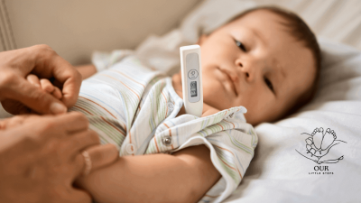 A concerned parent comforting their baby while managing common baby sickness symptoms like fever or cold