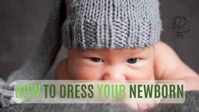 A collection of essential baby clothes, including onesies, sleepers, and hats, for dressing a newborn.