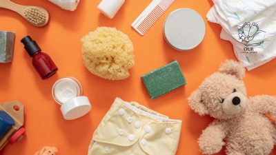 A collection of eco-friendly baby products including organic diapers, wooden toys, and biodegradable wipes displayed together.  