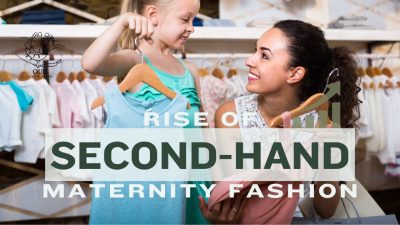 A pregnant woman browsing a rack of stylish second-hand maternity clothes.