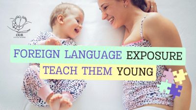 A happy toddler listening to language learning audio while playing with colorful alphabet blocks.